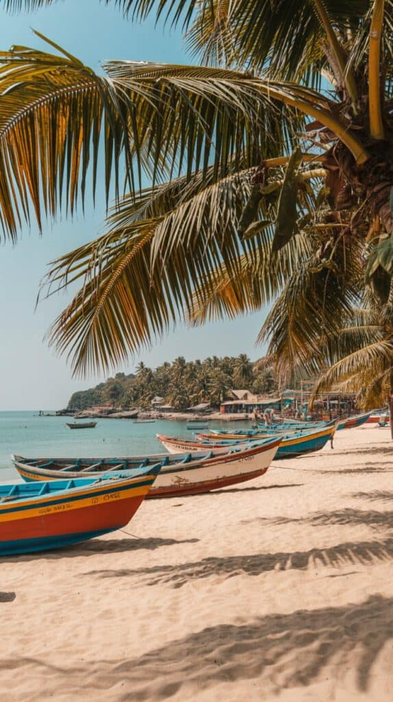 Oceanfront Yoga Retreats: Tropical beach scene with colorful boats on sandy shore, framed by lush palm trees. Calm blue sea under clear sky, conveying a serene, sunny vibe.